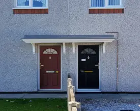 Double Georgian GRP canopy spanning two entrances on an EWI refurbishment project